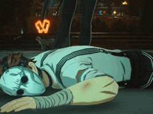 a man wearing a mask is laying on the ground with a heart in the background