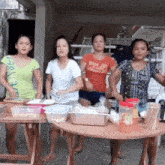 a group of women standing around a table with one wearing a shirt that says ram