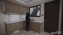 a woman standing in a kitchen with the words made in animotica on the bottom right