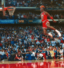 a basketball player is jumping in the air while wearing a number 23 jersey