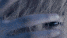 a close up of a person 's face with a white shirt on