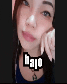 a close up of a woman 's face with the word halo written on it