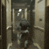 a blurry photo of a person running down a hall