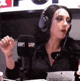 a woman wearing headphones is talking into a microphone that says rock pop