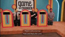 three men are kneeling in front of a game changer sign