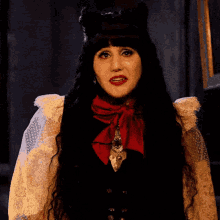 a woman with long black hair wearing a red bow tie
