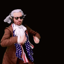 a man in a suit and scarf is wearing sunglasses and headphones