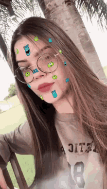a girl wearing glasses and a t-shirt with the number 18 on it
