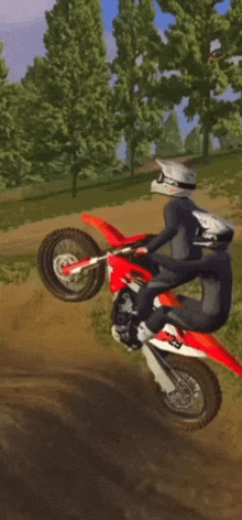 a person riding a dirt bike on a dirt road