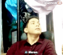 a man in a maroon shirt says a : meron