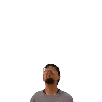 a man with glasses and a beard is looking up at the number 34