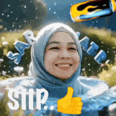 a woman in a blue hijab is smiling and giving a thumbs up sign