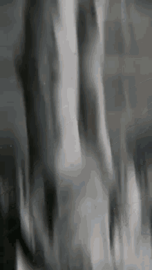 a blurry black and white photo of a person 's feet in a dark room .