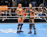 two wrestlers in a ring with a sign that says made in spain on it