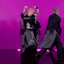 a group of men are dancing in front of a pink background
