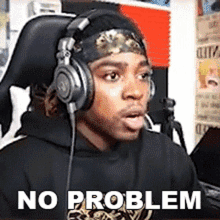 a man wearing headphones and a headband says no problem