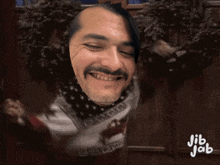 a man with a beard and mustache is smiling with jib jab written below him