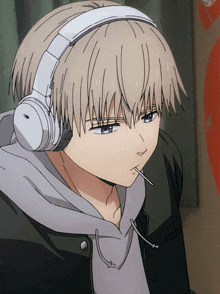 a person wearing headphones and a hoodie smoking a cigarette