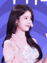 a woman in a white dress waving her hand
