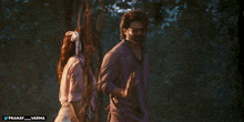 a man and a woman are standing in a forest with the words pranay and varma below them