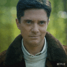 a close up of a man 's face with a netflix logo on the bottom