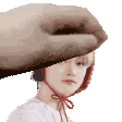 a woman wearing a hat and headphones is being held by a large hand .