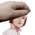 a woman wearing a hat and headphones is being held by a large hand .
