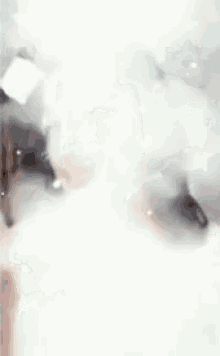 a woman is taking a picture of herself in a bathtub with bubbles coming out of her hair .