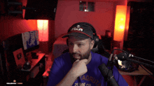 a man wearing headphones and a hat that says war on it
