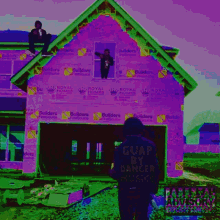 a picture of a house that is being built with builders on it
