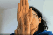 a woman covering her face with her hands and glasses
