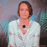 a woman wearing a necklace and a white shirt has the hashtag #ashtvtroll at the bottom of the screen