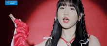 a girl is wearing a red and white outfit with a blue sign that says upfront works