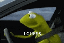 kermit the frog is sitting in the driver 's seat of a car .