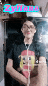 a woman wearing headphones and a black shirt with the name zyliana on it
