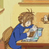 a girl is sitting at a table with a tray of food