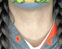 a close up of a person 's neck wearing a mask