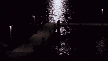 a black and white photo of a dock and water