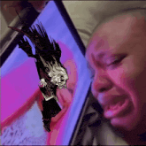 a man is crying while looking at a drawing of a ghost