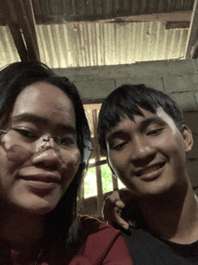 a man and a woman are posing for a picture and smiling for the camera
