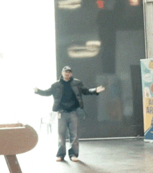 a man is standing in front of a sign that says ' all aboard '