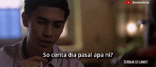 a man is sitting at a table with the words so cerita dia pasal apa ni below him