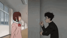 a boy and a girl are standing next to each other in a hallway and talking .