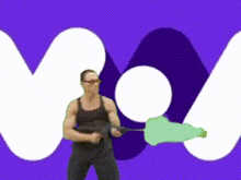 a man is holding a gun in front of a purple background with the letter m