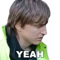 a man in a yellow jacket has the word yeah written on his face