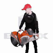 a boy wearing a ny hat is holding a stihl circular saw