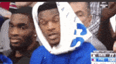 a man wearing a blue sweatshirt with the number 108 on the front