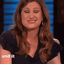 a woman in a black shirt is smiling with the words " and it " next to her