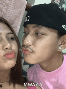 a man with a mustache is kissing a woman on the cheek with mwaaa written on the bottom