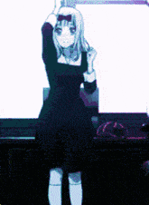 a girl in a black dress and white socks is dancing